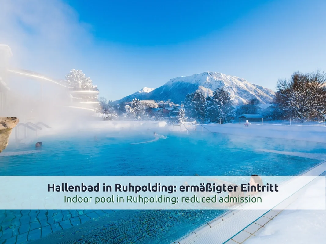 Ausflugsziel Vita Alpina in Ruhpolding: dampfendes Außenbecken im Winter mit Rutsche und verschneiten Bäumen